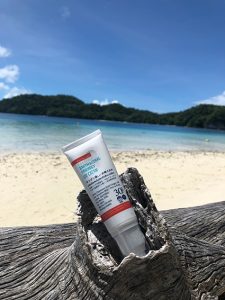 sunscreen product in a log on the beach