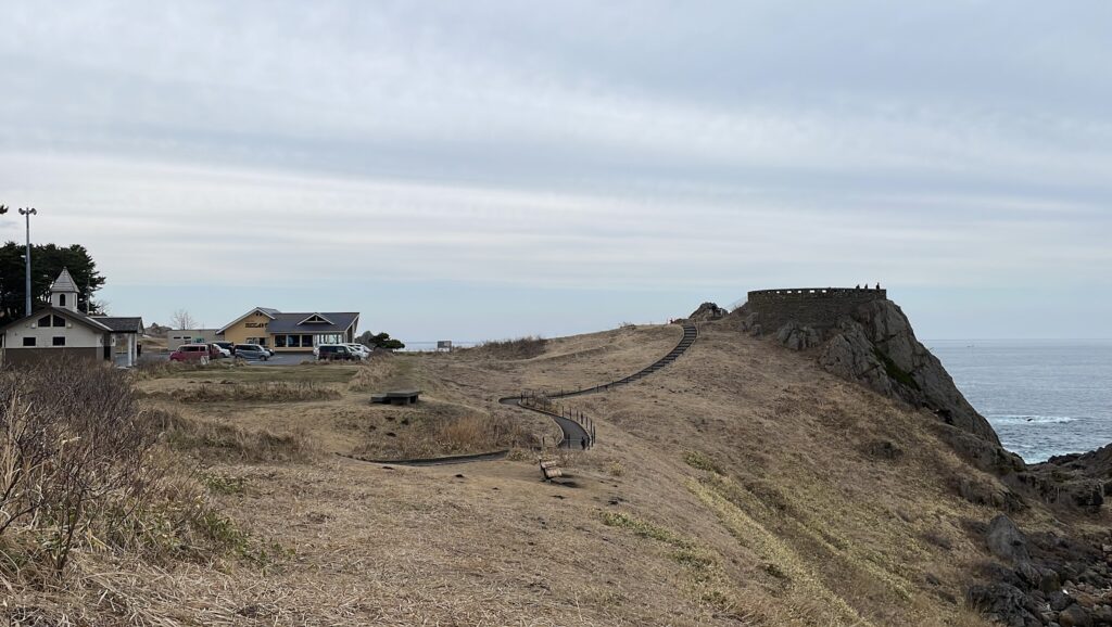 An open space near a beach cliff that hosts an observatory.